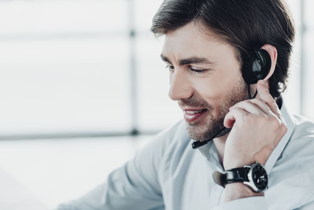 smiling-support-hotline-worker-in-headphones-with-2021-10-14-21-18-53-utc